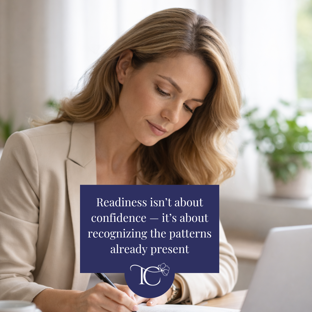 Woman reviewing notes beside a laptop, reflecting on readiness for a fractional executive career