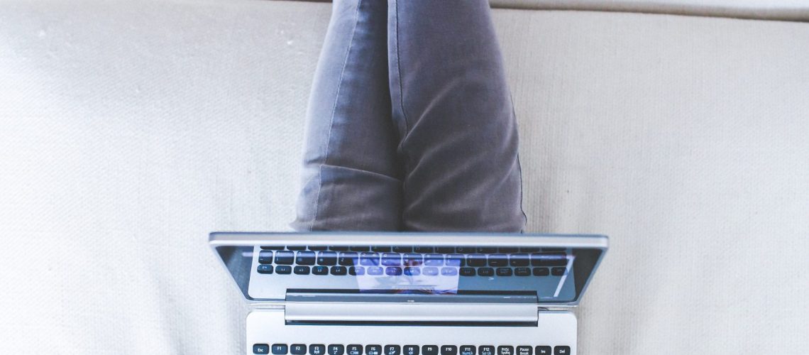 woman-lying-and-typing-on-laptop-6249